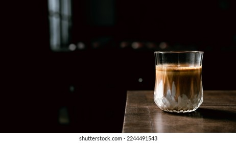 Dirty Coffee - A glass of espresso shot mixed with cold fresh milk in coffee shop cafe and restaurant - Shutterstock ID 2244491543