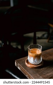 Dirty Coffee - A glass of espresso shot mixed with cold fresh milk in coffee shop cafe and restaurant - Shutterstock ID 2244491545
