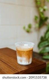 Dirty Coffee In Takeaway Glass On Wood Table