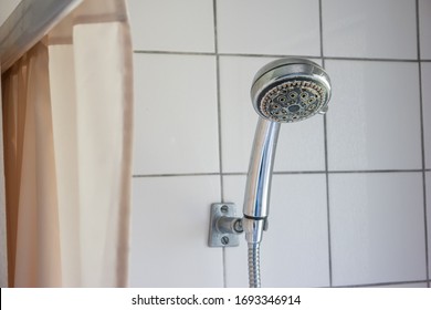 Dirty Corroded Limescale Calcified Shower Head Hanging From A Stand Inside Cabin Visible Curtain 2020