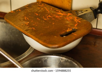 Dirty Cutting Board Next To The Sink. Dirty Unwashed Dishes After Cooking Dinner. Everyday Chores. Selective Focus.