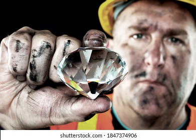 A Dirty Diamond Miner Covered In Soot Shows Off A Precious Gem Found In A Coal Mine.