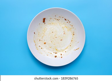 Dirty Dish On Blue Background. Top View
