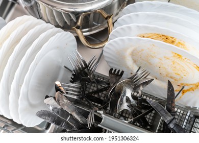 Dirty Dishes And Cutlery In A Dishwasher 