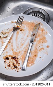 Dirty Dishes In The Kitchen Sink. Food Sauce Stained Porcelain Dishes And Utensils, No People, Top View.