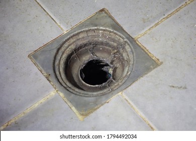 Dirty Drain In Bathroom And Rusty Metal Close Up.