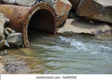 Dirty drain polluting a river. This pollutan comes from factory