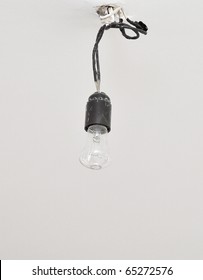 Dirty Electrical Lamp Hanging On Cable