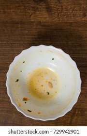 Dirty And Empty Bowl On A Wooden Background. With Copy Space. Top View