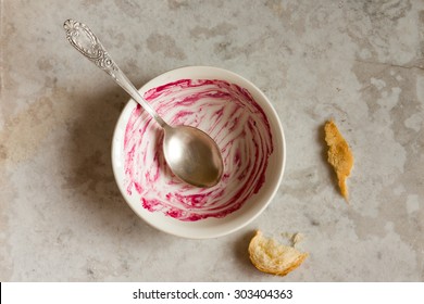 Dirty Empty Bowl And Spoon (dish) After Tasty Breakfast Over Stone Table