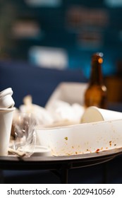 Dirty Empty Living Room With Food Trash, Bottle Of Beer And Napkins On Blue Sofa. Unorganized House Apartment Of Lonley Woman With Anxiety Depresion Having Garbage, Rubbish With No People In