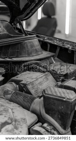 Dirty engine and engine compartment with dust before car wash. Car wash, detailing studio, car care.