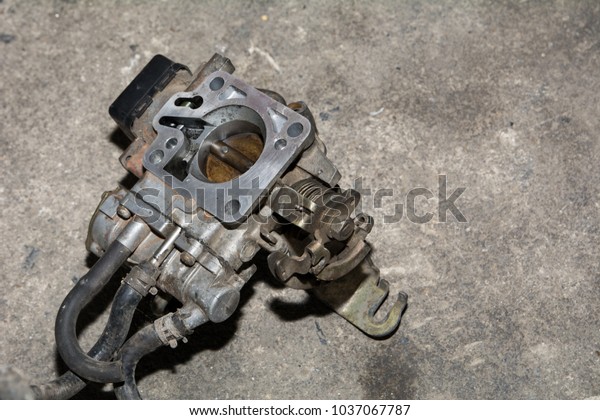 Dirty engine spare parts in\
garage