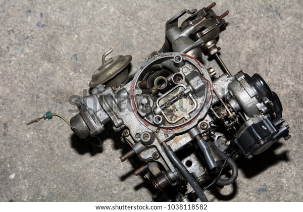 Dirty engine spare parts in\
garage