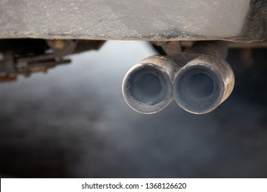 Dirty Exhaust Pipe Of Old Car. White Smoke And 2.5 PM Dust Air Pollution.