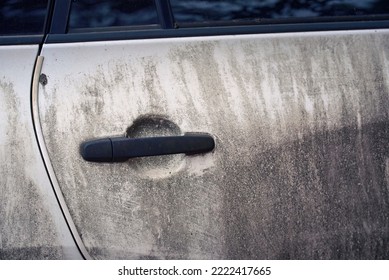 Dirty exterior door handle of vehicle. Dirty white car side view. Texture of mud on white car. Dirty SUV car after  adventure on messy road. Car wash concept