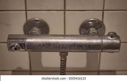 Dirty Faucet With White Tiles In The Background