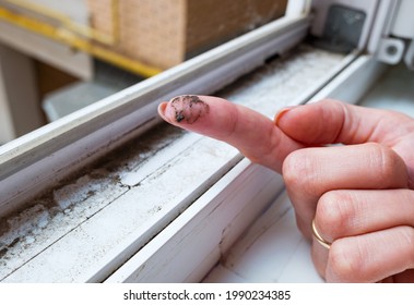 A Dirty Finger With Dirt Showing The Need For Cleaning The House, Washing PVC Window Frames. Cleaning Concept.