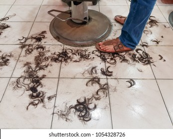 Dirty Floor Of A Hair Salon With Hairs On Floor In Barber Shop