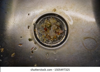 Dirty Food Waste On The Drainage Of A Kitchen Sink