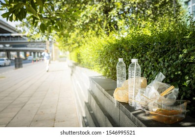 Dirty food waste,rubbish along the walkway,tourists littering or leaving in public areas,concept of throw your trash in a trash can,environmental conservation,plastic pollution,stop using plastic