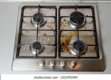 Dirty Gas Stove In The Kitchen, Top View. Gas Stove With Food Remnants.