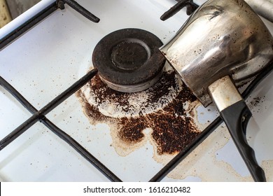 dirty gas stove with spilled coffee from Cezve, front and background blurred with bokeh effect - Shutterstock ID 1616210482