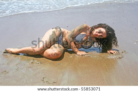 Dirty girl in bikini on the beach.