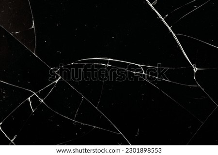 Dirty glass broken into a large number of pieces and parts, a piece of glass with a lot of cracks and broken parts