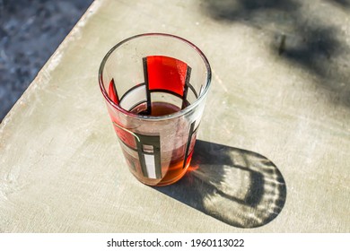 Dirty Glass Glass With Cheap Wine On The Table In The Sun