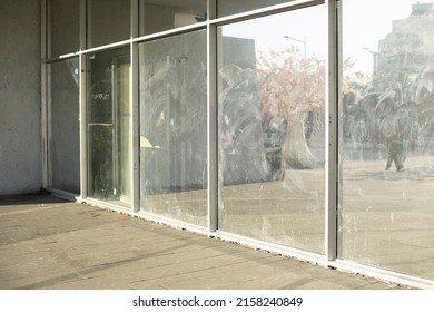 Dirty Glass In Display Case. Broken Glass In Building. Large Mirrors On Street.