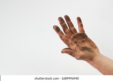Dirty hand isolated on a white background with copy space. Man show his dirty hands with palms,  close-up