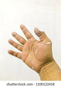 Dirty hand with white paint on white background. Selective focus.