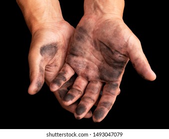 dirty hands after work on a black background