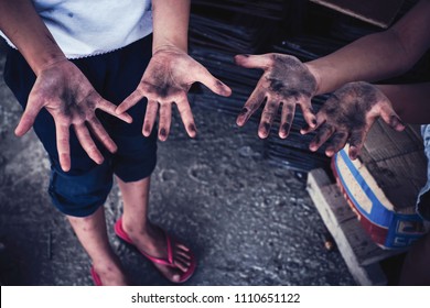 Dirty Hands Of Children From Construction Work. World Day Against Child Labour Concept.