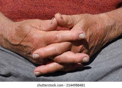Dirty hands of an elderly man crossed, hands of a farmer at rest