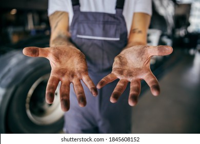 Dirty Hands Of Hardworking Employee In Overalls. Manual Jobs Concept.