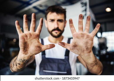 Dirty Hands Of Hardworking Employee In Overalls. Manual Jobs Concept.