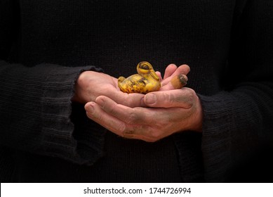 Dirty Hands Holding A Small Rubber Duck