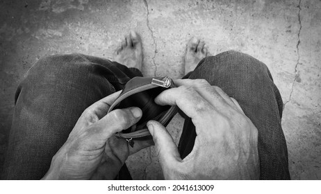 The Dirty Hands Of A Homeless Poor Man With An Empty Wallet. An Unemployed Man. Bankruptcy Of The Enterprise. Poverty And Misery. Citizens In Need. Hunger And Cold. Bare Feet Without Focus.