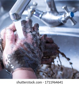 Dirty Hands In The Mud Washing Under The Sink