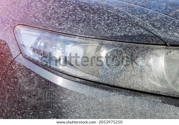 dirty headlight of\
the car. The concept of washer fluid, cleaning, polishing. Detail\
of the car. Close-up