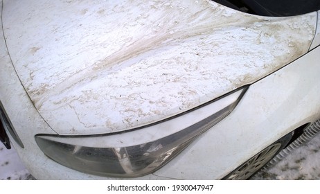 Dirty Headlight, Muddy Glass. Mud On White Hood Of Automobile. Car Wash. Washing The Body. Cleaning Vehicle. Corrosion Protection Concept. Automotive Finishes And Paints. Bodywork. Safety Driving.