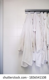 Dirty Lab Coats Hanging In A Laboratory. Research Concept.