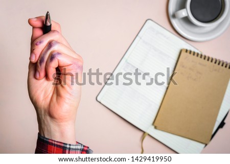 Dirty left hand after writing. Left hander day concept. Working place of lefty