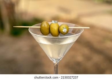 Dirty martini with green olives and blue cheese, vodka mixed alcoholic drink