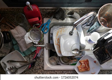 Dirty, Messy Kitchen With Utensils And Pots And Pans