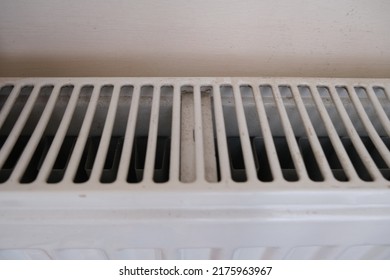 Dirty Modern Panel Radiator On Beige Wall