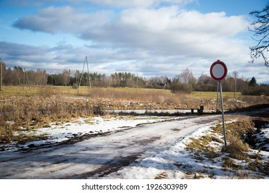 Dirty Mud Road In Winter With Water On The Surface. Sunny Day With Snow