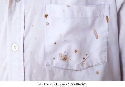 Dirty Mud Stain On White Shirt From Kid Playing In Rainy Day. Dirty Stains For Cleaning Concept 